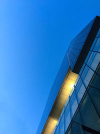 Low angle view of modern building against clear blue sky