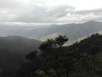 Scenic view of mountains against cloudy sky