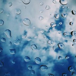 Full frame shot of raindrops on glass window