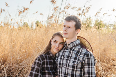 Portrait of young couple on field