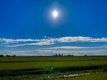 Scenic view of landscape against blue sky