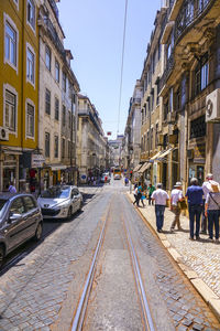 Cars on street amidst buildings in city