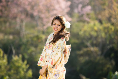 Portrait of a smiling young woman standing outdoors