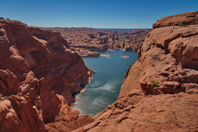 Scenic view of rocks and mountains against clear sky lake powell 