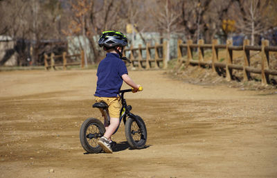 Boy cycling on field