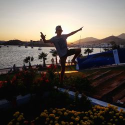 Full length of woman standing on boat against sky during sunset