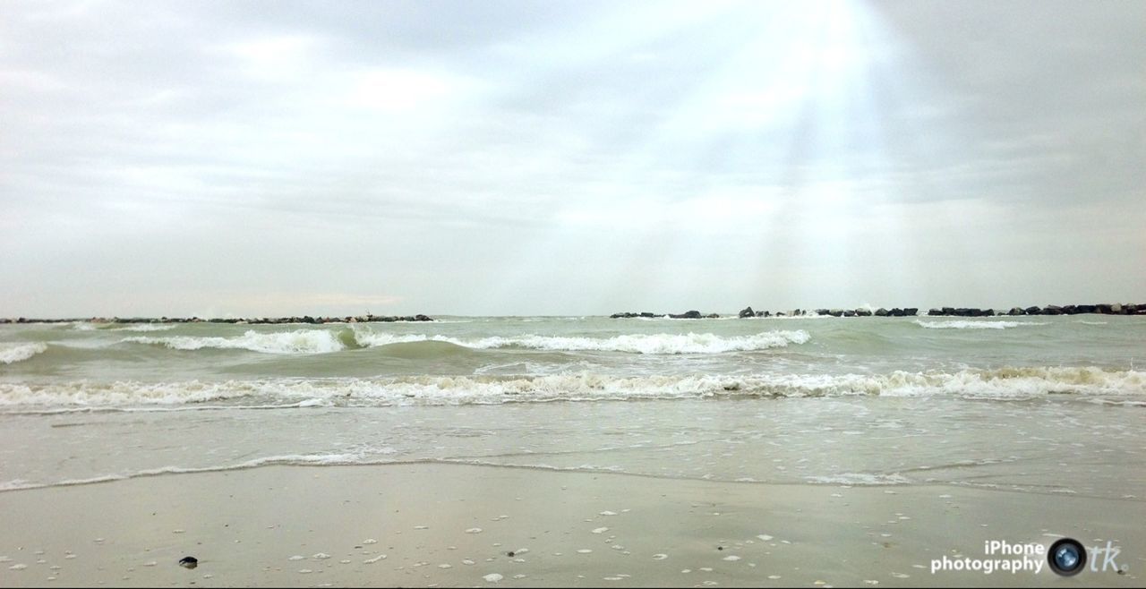 sea, water, beach, horizon over water, sky, shore, scenics, beauty in nature, wave, tranquil scene, tranquility, cloud - sky, nature, sand, surf, idyllic, sunlight, cloudy, motion, day