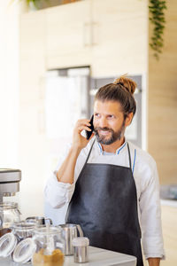 Midsection of man using mobile phone