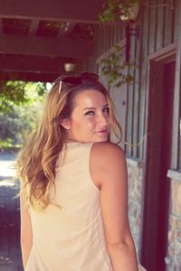 Portrait of beautiful young woman standing indoors