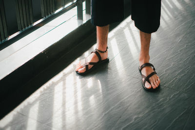 Low section of woman standing on floor