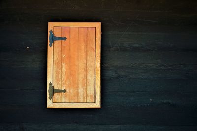 Close-up of closed door on wooden table