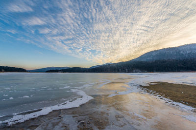 Scenic view of lake against sky during sunset