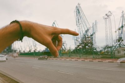 Close-up of hand against built structure