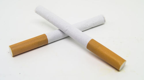 High angle view of cigarette smoking on white background