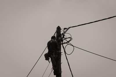 Low angle view of silhouette man against clear sky