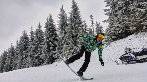 Portrait of mid adult man skiing in snowcapped mountain