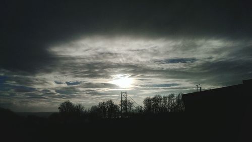 Low angle view of silhouette trees against sky