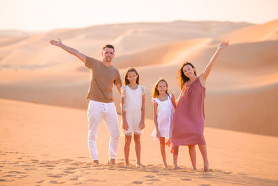 Full length of people standing on beach