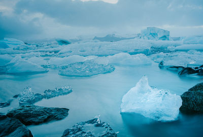 Calm image in diamonds beach with small polar ice caps detached from a glacial