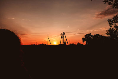 Silhouette plants on field against sky during sunset