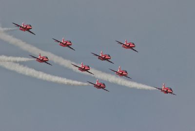 Low angle view of airshow against clear sky