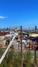 High angle view of construction site by buildings against sky