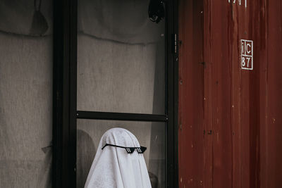 Low section of person standing by door of building