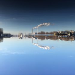 Upside down image of smoke stack reflection in lake
