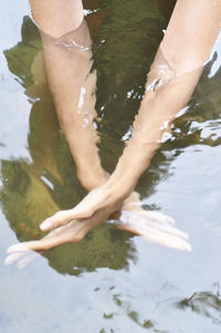 Low section of woman swimming in water