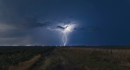 Scenic view of lightning over field