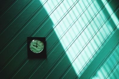 Low angle view of clock on window