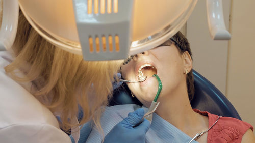 Cropped image of dentist examining patient