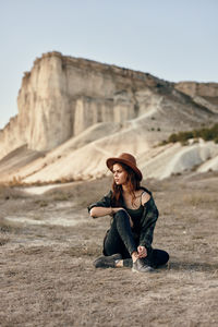 Young woman sitting on rock