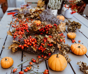 Handmade colorful floral autumn door wreath made of colorful rosehip berries, rowan, dry flowers 