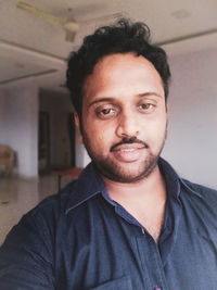 Portrait of smiling young man at home