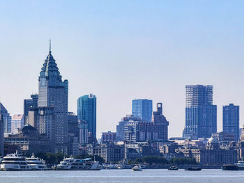 Buildings in city against clear sky in shanghai, china