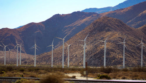 Scenic view of mountains and wind turbines 