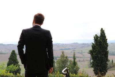 Rear view of woman standing on landscape