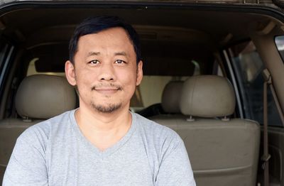 Portrait of man sitting in car