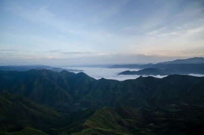 Scenic view of mountains against cloudy sky