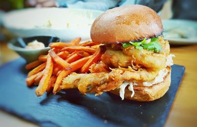 Close-up of burger with french fries on table