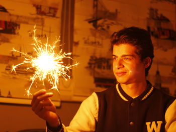 Portrait of young man smiling at night