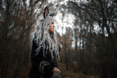 Woman standing in forest