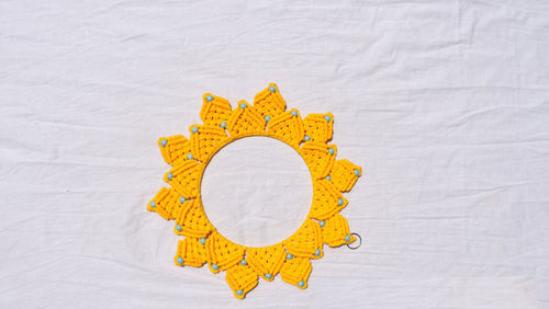 High angle view of yellow umbrella on paper