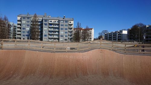 Buildings against clear blue sky