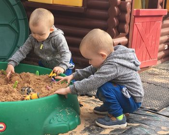 Baby boys playing with toys at playground