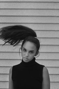 Close-up portrait of teenage girl against wall