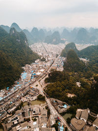 High angle view of buildings in town against sky