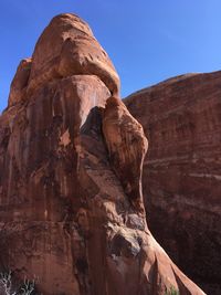 Low angle view of rock formation against clear sky