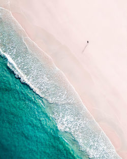 Aerial view of man walking on beach